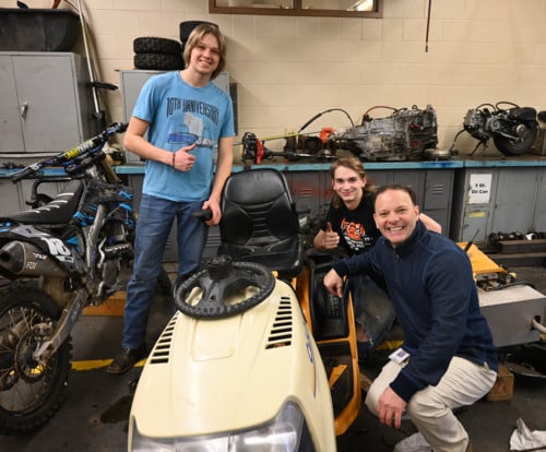 Students and Superintendent Miller on Auto Shop